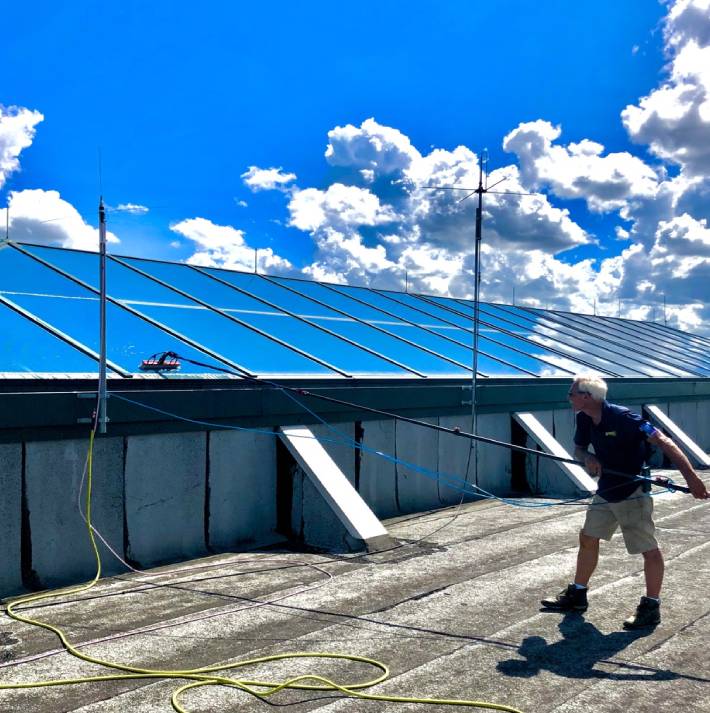 Cleaning skylight windows on a warehouse in Hilton Head.