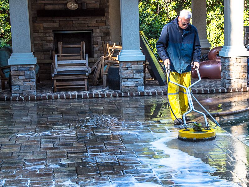 Meticulous attention to detail cleaning concrete paver stones.