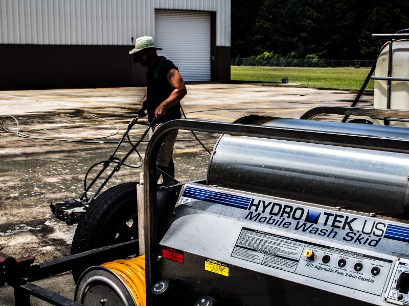 Our Sunco techs cleaning a commercial warehouse parking lot concrete.