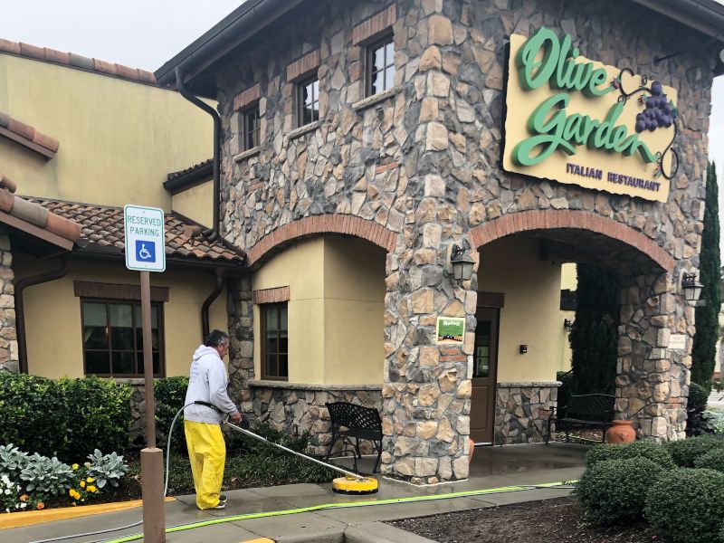 Commercial concrete cleaning at a local Olive Garden restaurant.