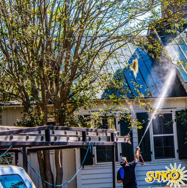 Washing a metal roof on a house in Hilton Head.