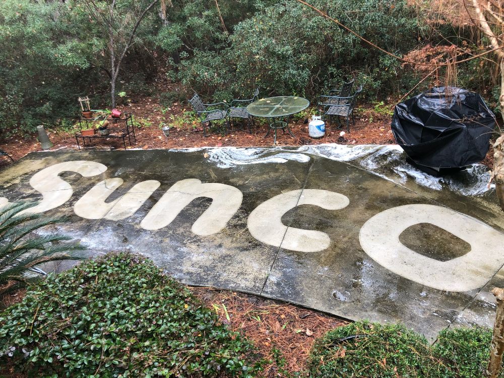 Having fun with dirty concrete. Sunco logo on concrete.